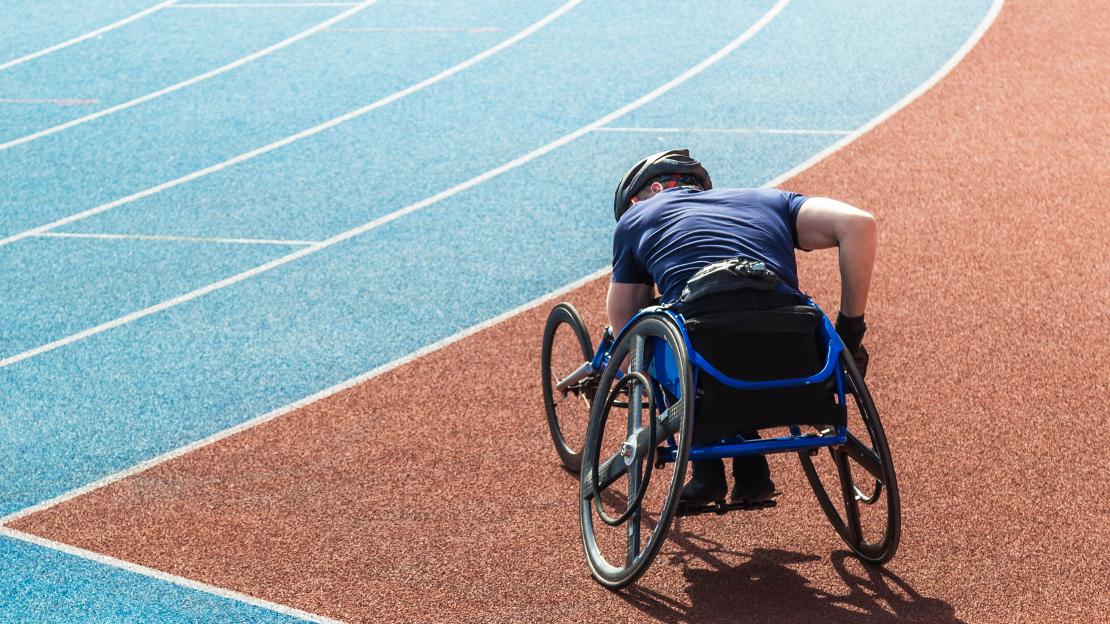 A man in a wheelchair is standing on a treadmill